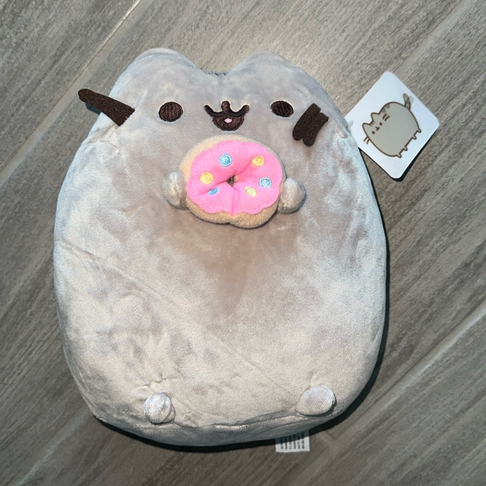 I am selling a donut pusheen plush holding a donut